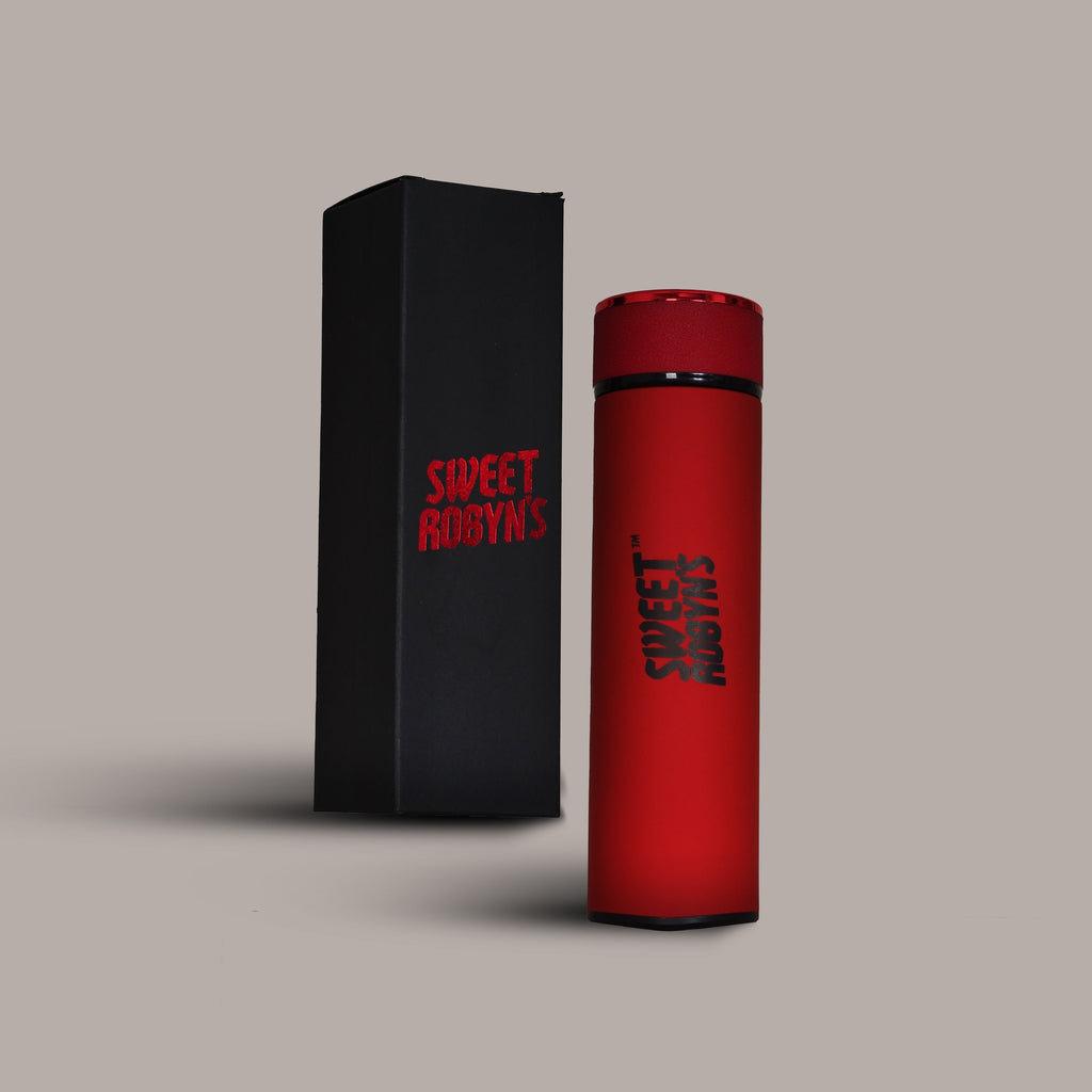 A red stainless steel flask with black text, displayed next to its packaging box which has "SWEET ROBYNS" written on it.